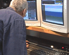 Dave leans over a mixing desk